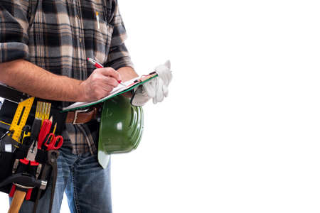 Carpenter isolated on white background writes work notes on a notebook. Work tools industry construction and do it yourself housework. Stock photography.の写真素材