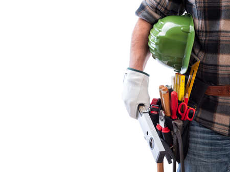 Carpenter isolated on a white background; he wears leather work gloves, holds the level in his hand....