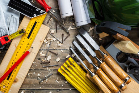 View from above of carpenter's tools on an antique wooden table. Construction industry, do it yourself. Wooden work table.の写真素材