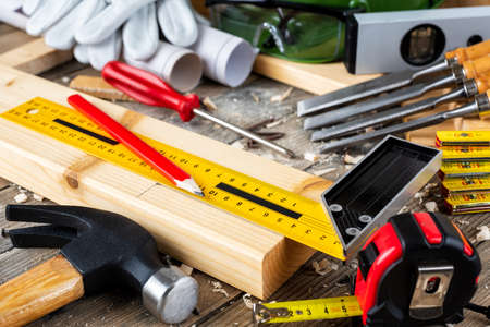 View from above of carpenter's tools on an antique wooden table. Construction industry, do it yourself. Wooden work table.の写真素材