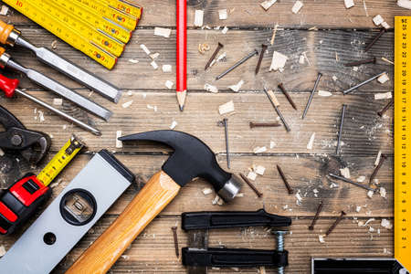 Top view of carpenter's tools on an antique wooden table. Construction industry, do it yourself. Wooden work table.の写真素材