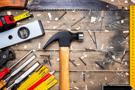 Top view of carpenter's tools on an antique wooden table. Construction industry, do it yourself. Wooden work table.の写真素材