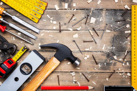 Top view of carpenter's tools on an antique wooden table. Construction industry, do it yourself. Wooden work table.の写真素材