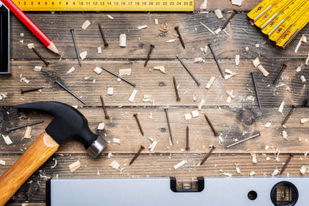 Top view of carpenter's tools on an antique wooden table. Construction industry, do it yourself. Wooden work table.の写真素材