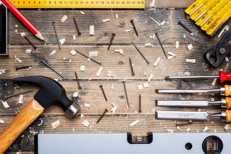 Top view of carpenter's tools on an antique wooden table. Construction industry, do it yourself. Wooden work table.の写真素材