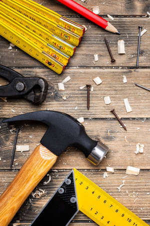 Top view of carpenter's tools on an antique wooden table. Construction industry, do it yourself. Wooden work table.の写真素材