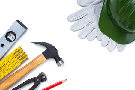 View from above of carpenter's tools, helmet and leather protective gloves on a white background. Industry construction, work safety. Text space.の写真素材