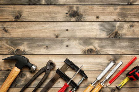 Top view of carpenter work tools on an antique wooden table. Construction industry, do it yourself. Text space.の写真素材