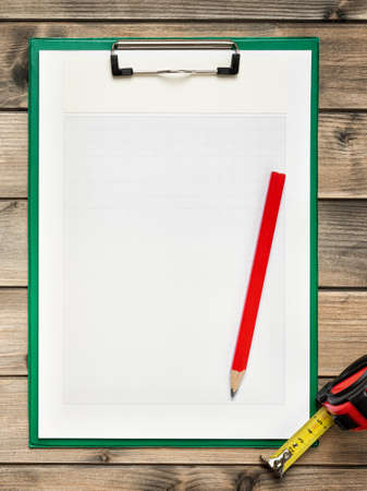 Top view of carpenter work tools and notebook for notes on an antique wooden table. Construction industry, do it yourself. Text space.の写真素材