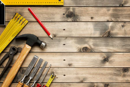 Top view of carpenter work tools on an antique wooden table. Construction industry, do it yourself. Text space.の写真素材