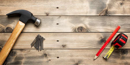 Top view of the hammer and carpenter's work tools on an antique wooden table. Construction industry, do it yourself. Text space.の写真素材