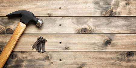 Top view of the hammer and carpenter's work tools on an antique wooden table. Construction industry, do it yourself. Text space.の写真素材