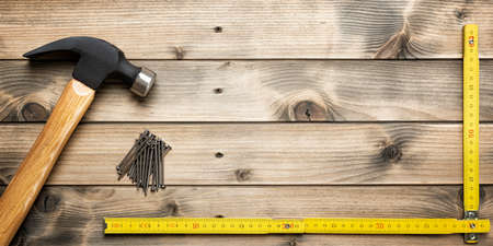 Top view of the hammer and carpenter's work tools on an antique wooden table. Construction industry, do it yourself. Text space.の写真素材