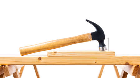 Close-up. Carpenterâs hammer over a wooden board. Construction industry, do it yourself. White background.の写真素材