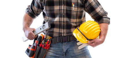 Electrician holds the level in his hand, helmet with protective goggles. Construction industry, electrical system. Isolated on a white background.の写真素材