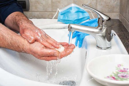 Coronavirus prevention. Hand washing with hot soapy water, the use of the mask and gloves stops the infection from Covid-19. Personal hygiene. Health.の写真素材