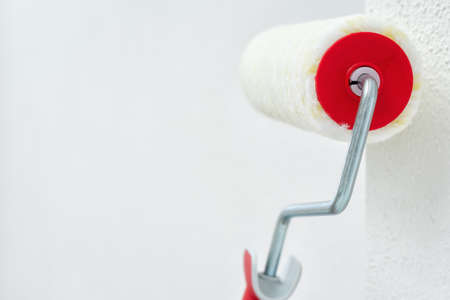 Roller for painting leaning against the wall. Construction industry. Work safety.の写真素材