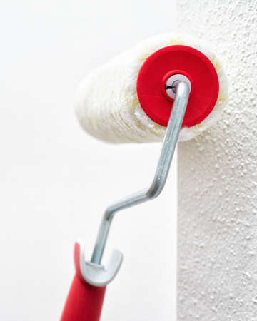 Roller for painting leaning against the wall. Construction industry. Work safety.の写真素材