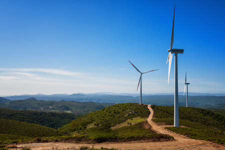Wind turbines on a beautiful blue sky in a mountain wind farm in Sardinia. Renewable energy concept, green energy generation. Energy industry.の写真素材