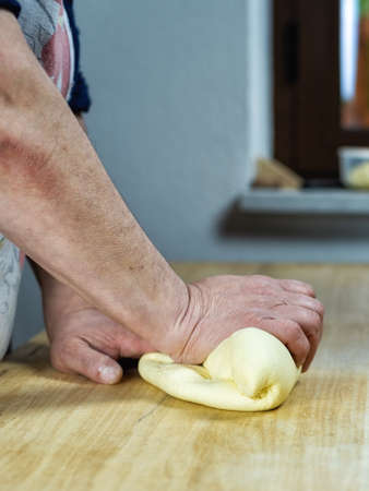 Close-up of woman's hands working the dough to prepare cheese ravioli. Traditional Sardinian cuisine.の写真素材