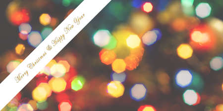 Merry Christmas and Happy New Year greeting card, blurred background of the twinkling lights of the...