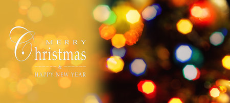 Merry Christmas and Happy New Year greeting card, blurred background of the twinkling lights of the...