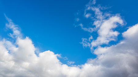 Landscape of a beautiful blue sky covered with cumulonimbus clouds on a winter afternoon. Unspoiled nature.の写真素材