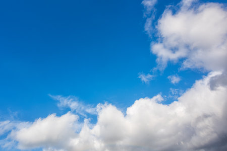 Landscape of a beautiful blue sky covered with cumulonimbus clouds on a winter afternoon. Unspoiled nature.の写真素材