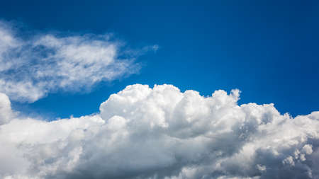 Landscape of a beautiful blue sky covered with cumulonimbus clouds on a winter afternoon. Unspoiled nature.の写真素材