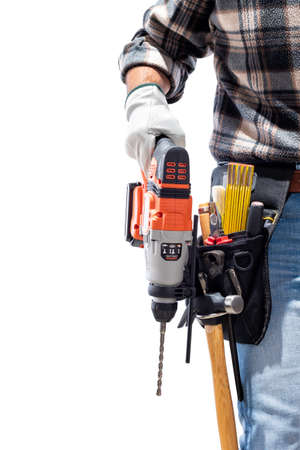 Carpenter worker at work holding rechargeable hammer drill, isolated on white background. Construction industry. Carpentry.の写真素材