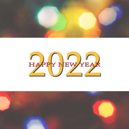 Happy New Year 2022 greeting card, blurred background of the twinkling lights of the Christmas tree. Greeting card background.の写真素材