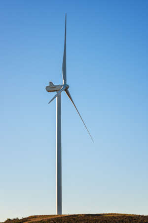 Wind turbines on a beautiful blue sky in a mountain wind farm in Sardinia. Renewable energy concept,...
