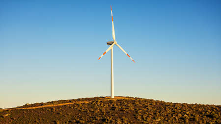 Wind turbines on a beautiful sunset sky in a mountain wind farm in Sardinia. Renewable energy concept, green energy generation. Energy industry.の写真素材