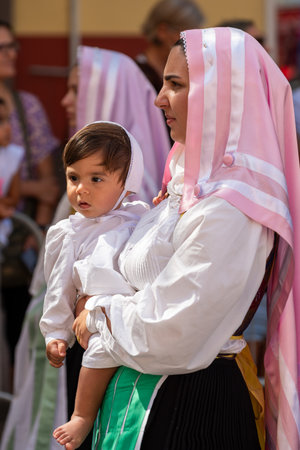Nuoro, Sardinia, Italy - August 27, 2023: Parade of traditional costumes of Sardinia on the occasion of the Feast of the Redeemer of the August 27, 2023 in Nuoro, Sardinia.のeditorial素材