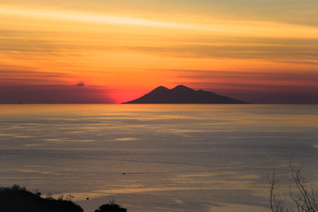Firing sunset over pacific ocean in Komodo tropical island, Indonesia