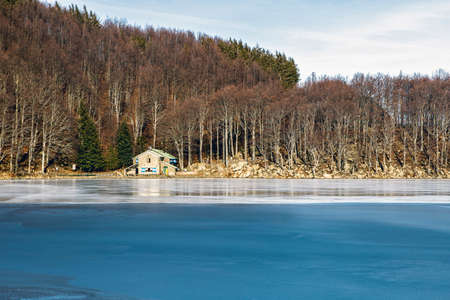 Mountain refuge and winter frozen lake in italian mountains, Parmaの写真素材