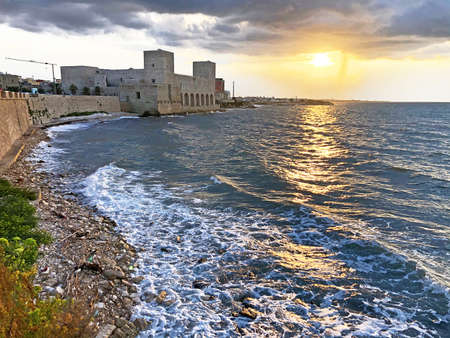 Scenic sunset seascape view of Trani italian medieval fortress, Pugliaのeditorial素材