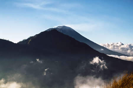 Agung volcano peak silhouette aerial view at sunrise, Bali Indonesiaの写真素材