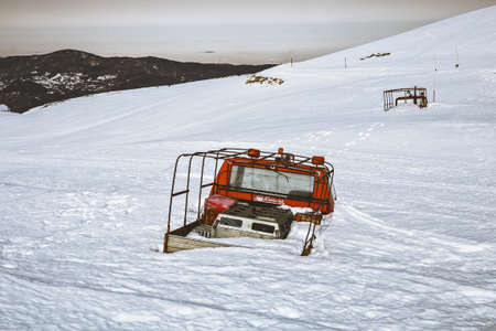 Abandoned alpine rescue car under heavy snow, Cimone, Modena, Italyの写真素材