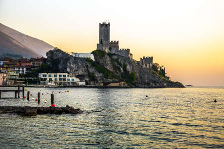Malcesine Scaligero castle and Italian village on Garda Lake at sunsetの写真素材