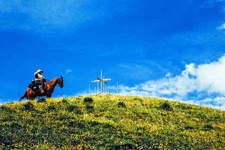 Man riding horse on mountain ridge, Emilian Apennines, Reggio Emilia, Italyの写真素材