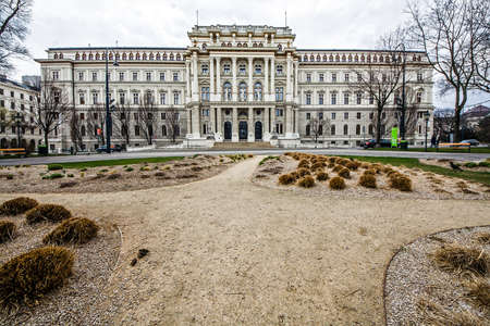 Scenic view of famous austrian palace against garden, empty square and a cloudy sky, Wien, Austriaのeditorial素材