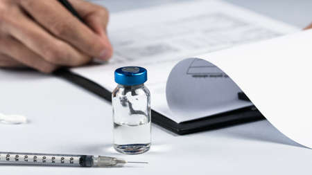 doctor prepares form for covid vaccination 3rd doseの写真素材
