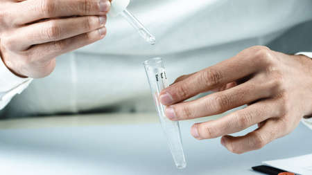 doctor applies reagent to covid 19 buffer. Omicron variant