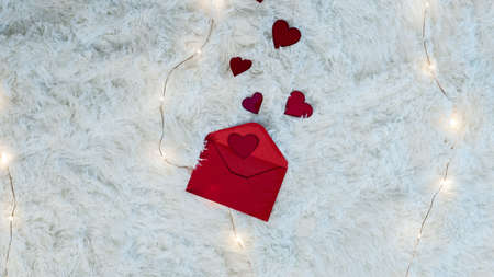 red letter for valentines day with red hearts backgroundの写真素材