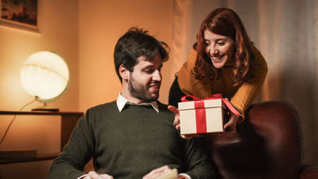 Girl gives valentine gift box to her boyfriend