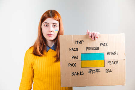 ukrainian girl holding an anti-war placard in her hand