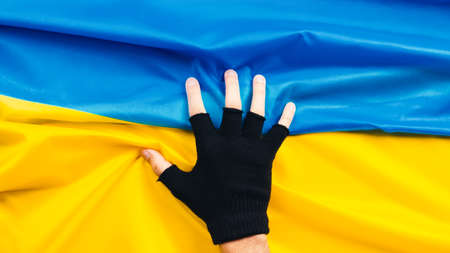 close up of hand holds flag of ukraineの写真素材