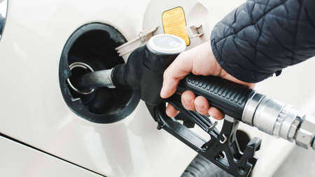 Close up of hand puts fuel pump into car