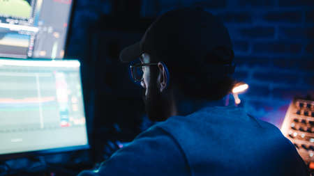 Music producer focused on work in recording studioの写真素材